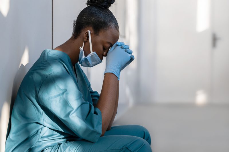 Tired,Depressed,Female,African,Scrub,Nurse,Wears,Face,Mask,Blue